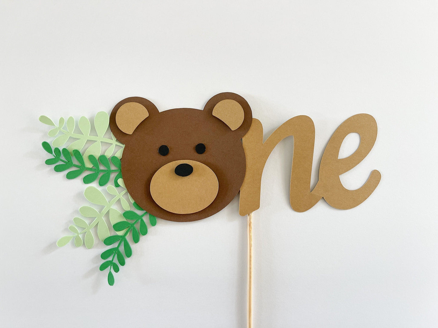 teddy bear first birthday cake topper with the word One