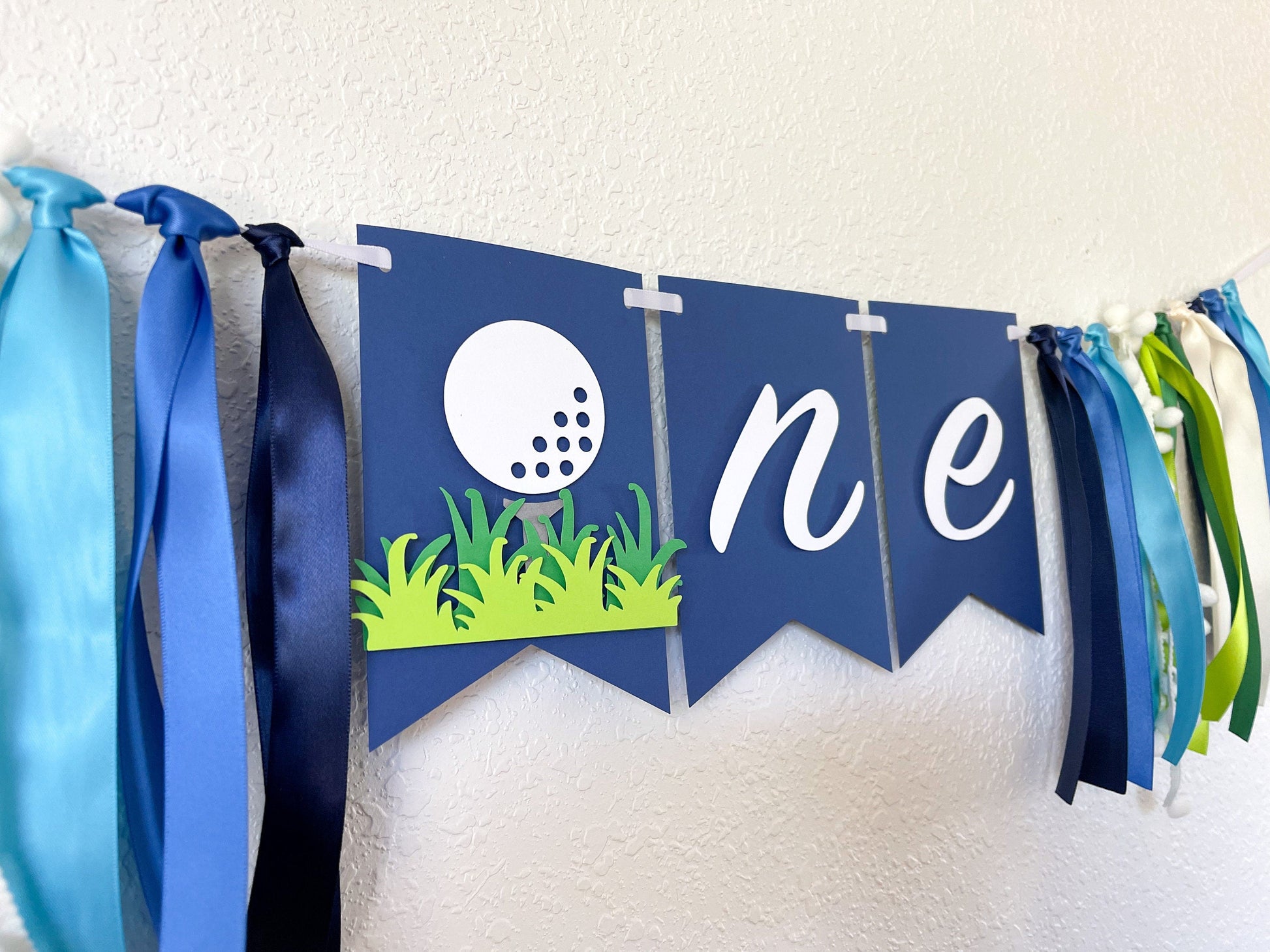golf themed highchair banner with ONE for first birthday