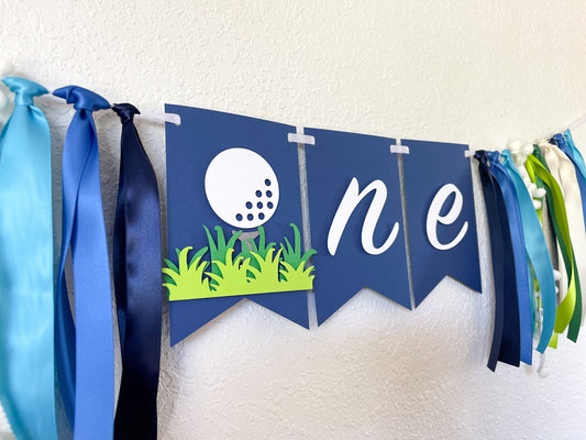 golf themed highchair banner with ONE for first birthday